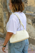 Sac Nour blanc cassé vu de dos, porté à l’épaule avec look casual